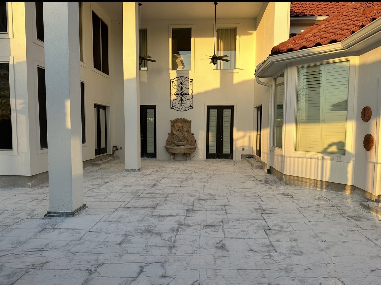 Backyard stamped concrete patio with pergola